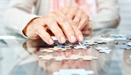 an adult with dementia solving a puzzle